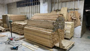 Raw wood stockpiles organized and prepared for use in premium furniture manufacturing.