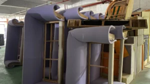 Large modular lounge furniture being assembled with internal support frames and soft foam.