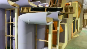 Furniture factory showing upholstery materials being applied to custom-designed frames.