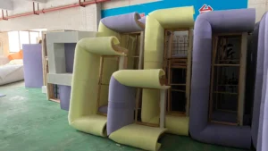 Colorful foam-wrapped furniture structures under fabrication, showcasing modern modular design.