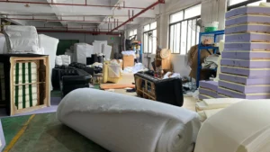 Skilled workers assembling upholstered furniture in a factory setting. High-quality craftsmanship for sofas and custom seating.