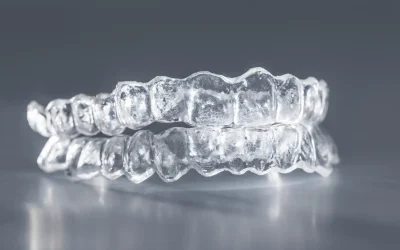 Multiple clear aligners stacked and ready for packaging and shipping.