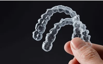 Group of orthodontic aligners laid out to showcase mass production capabilities.