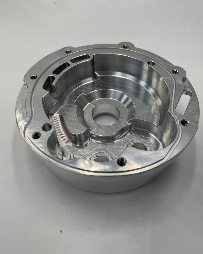 CNC-milled circular casing with threaded holes, ideal for motor covers or housings.
