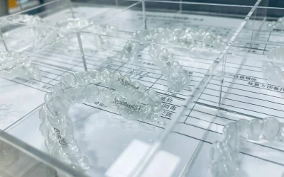Freshly molded aligners placed in sterilization trays for hygiene and quality control.