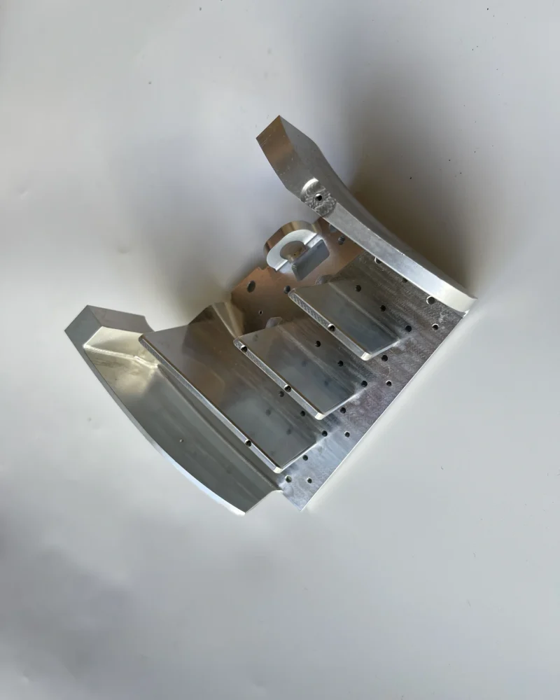 Machined housing component featuring milled pockets for electronics or modular parts.